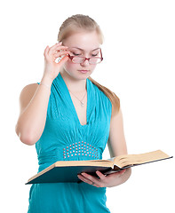 Image showing A young girl in glasses with a book