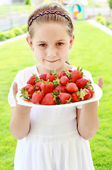 Image showing Girl holding fresh strawberries