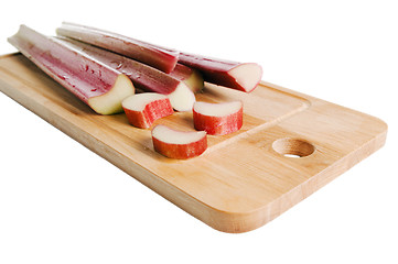 Image showing Rhubarb on a kitchen board, it is isolated on white