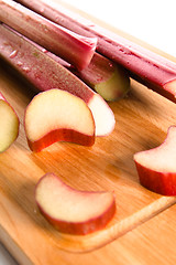 Image showing Rhubarb on a kitchen board, it is isolated on white