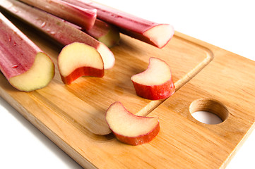 Image showing Rhubarb on a kitchen board, it is isolated on white