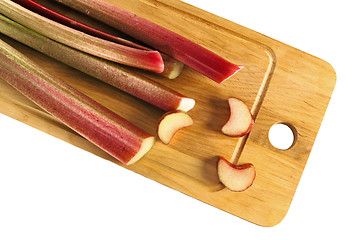 Image showing Rhubarb on a kitchen board, it is isolated on white
