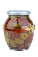 Image showing Green greek olives conserved with dried tomato and cheese in the glass jar