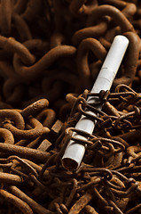 Image showing Chains holding down cigarette