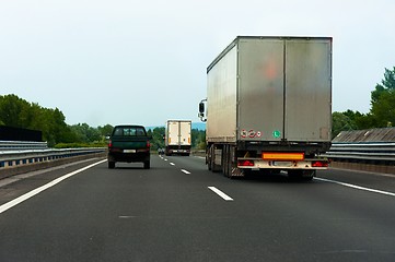 Image showing Trucks traveling on highway delivering goods
