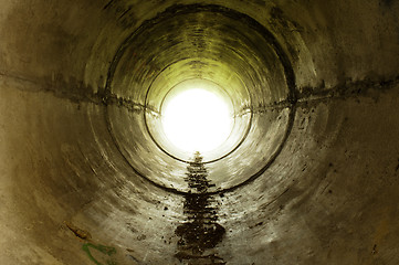 Image showing An industrial tunnel leading into the light