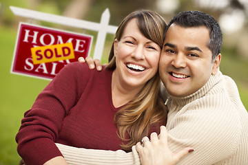 Image showing Mixed Race Couple in Front of Sold Real Estate Sign