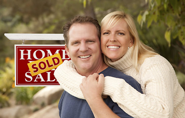 Image showing Happy Couple in Front of Sold Real Estate Sign