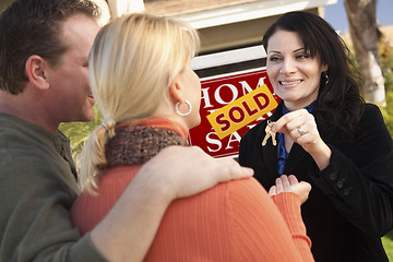 Image showing Attractive Hispanic Female Real Estate Agent Handing Over Keys