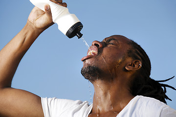 Image showing Young athletic man taking a break during a challenging jogging o