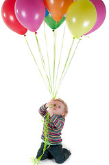 Image showing Little cute girl with multicolored air balloons