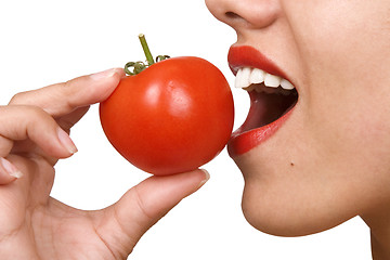 Image showing Young Woman Eating Tomatoes