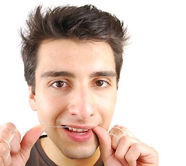 Image showing Man flossing his teeth