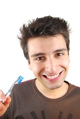 Image showing Cute guy washing his teeth