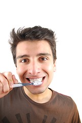 Image showing Cute guy washing his teeth