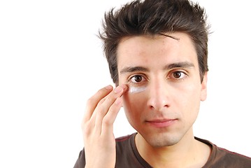 Image showing Handsome man applying eye cream