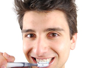 Image showing Cute guy washing his teeth