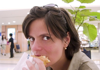 Image showing Girl eating snack