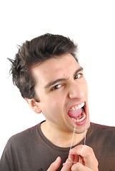 Image showing Man flossing his teeth (NO expression)