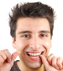 Image showing Man flossing his teeth