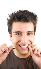 Image showing Man flossing his teeth