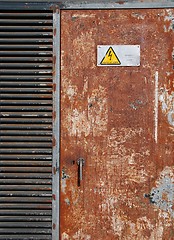 Image showing High voltage sign on a rusty door