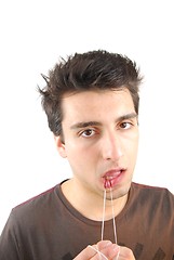 Image showing Man flossing his teeth (don't want expression)