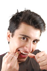 Image showing Man flossing his teeth