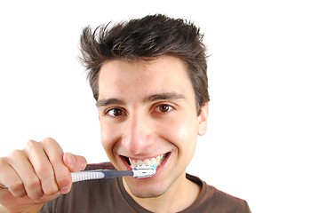 Image showing Cute guy washing his teeth