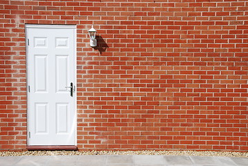 Image showing White door on a brick wall