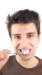 Image showing Cute guy washing his teeth