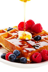 Image showing Syrup Pouring Over Waffles