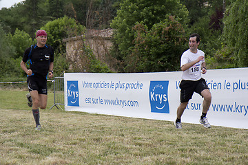 Image showing two runners next to the finishline