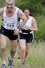 Image showing Woman running behind a man 