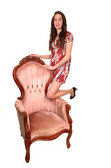 Image showing Girl standing on armchair.