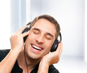 Image showing Smiling man listening the music