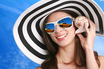 Image showing woman listens seashell