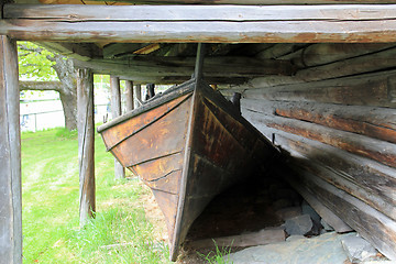 Image showing Old boat house and a boat