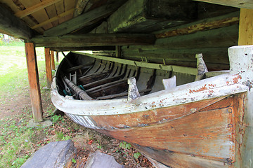 Image showing Old boat house and a boat