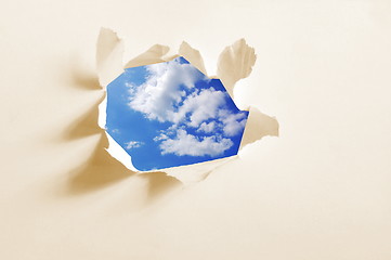 Image showing cloudy sky behind paper hole