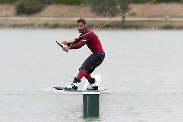 Image showing Wakeboarder riding his wakeboard