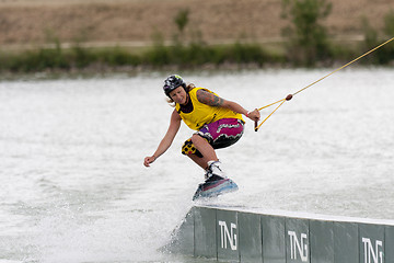 Image showing Woman riding her wakeboard