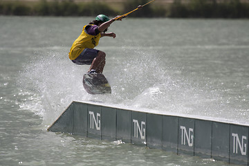 Image showing Young rider jumping with his wakeboard