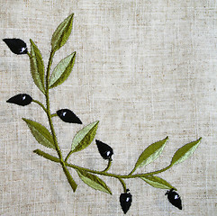Image showing Embroidery of olive branch on linen beige fabric 