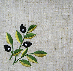 Image showing Embroidery of olive branch on linen beige fabric 