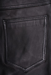 Image showing Pocket on the black leather texture as background 