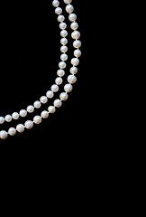 Image showing White pearls on the black silk 