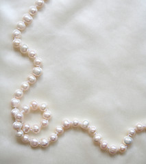 Image showing White pearls on the white silk 