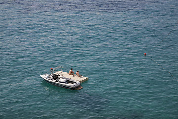 Image showing Couple sunbathing on raft