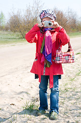 Image showing Cute Little Girl Takes Pictures